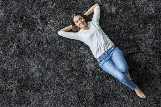 young woman relaxing on a fluffy carpet