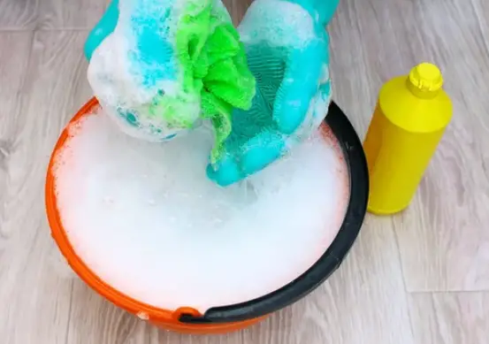 a bucket with soapy water