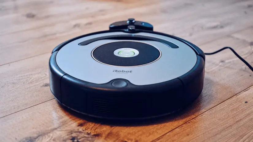 a robot vacuum cleaner on the wooden floor