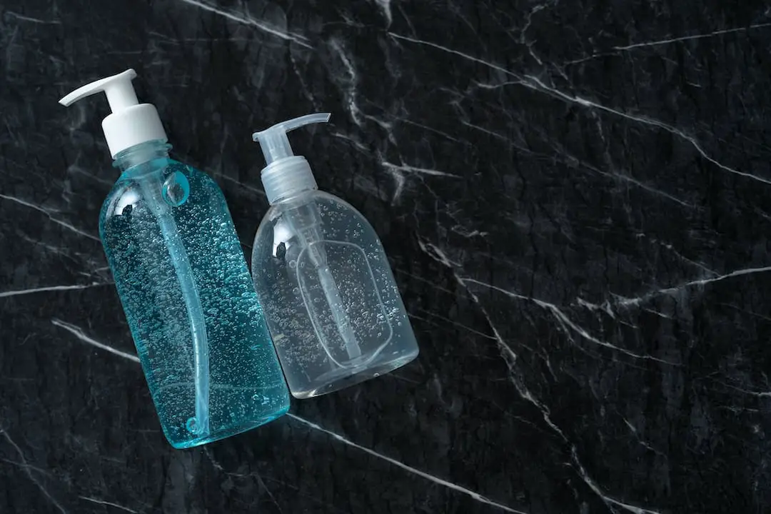 two bottles of liquid soap in different color