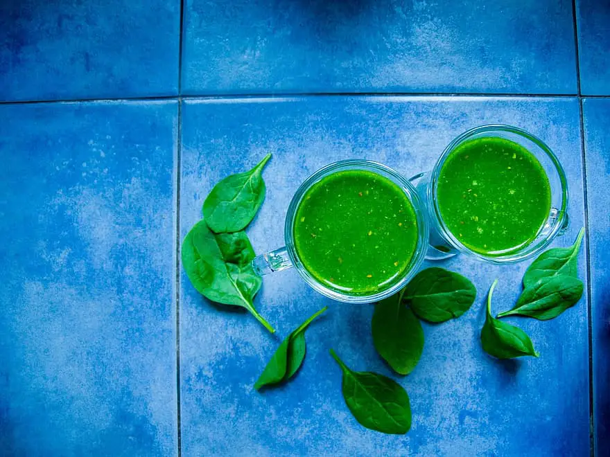 green drinks in glasses on the blue tiles